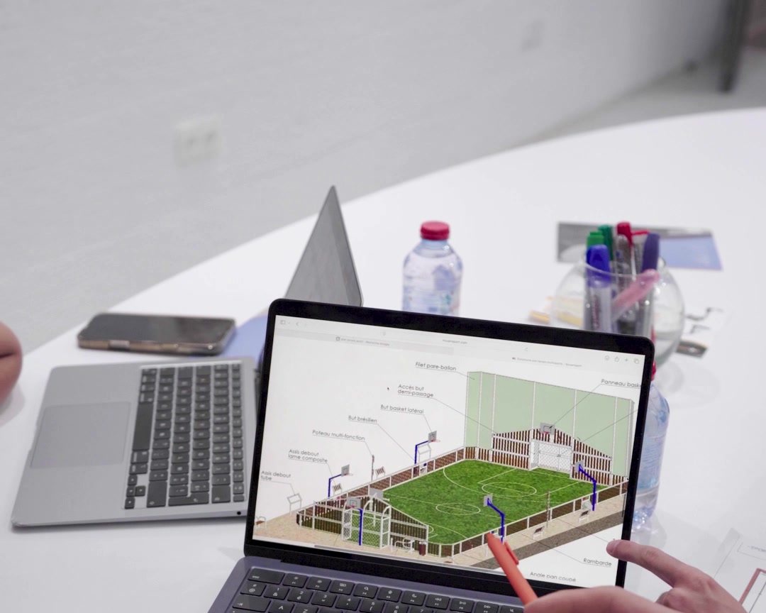 L'équipe Sportlogic étudie le plan 3D d'un terrain multisport avant réalisation